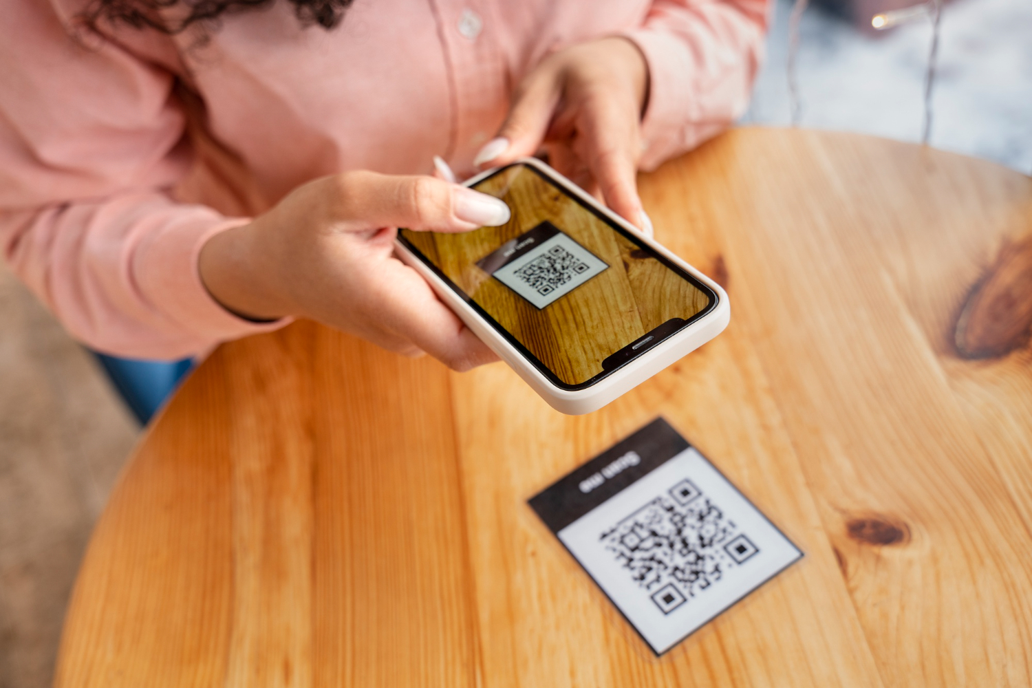woman scanning qr code with phone. Image from Freepik.